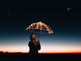 woman using umbrella with lights